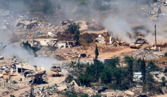 This picture taken from a position in the Upper Galilee in northern Israel, near the Israel-Lebanon border, shows Israeli Merkava tanks driving along a road past destroyed buildings in southern Lebanon on June 17, 2026.