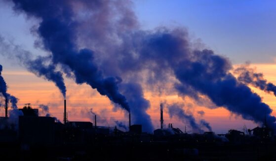 Pollution smoke from a factory plant pumping smoke into the air.