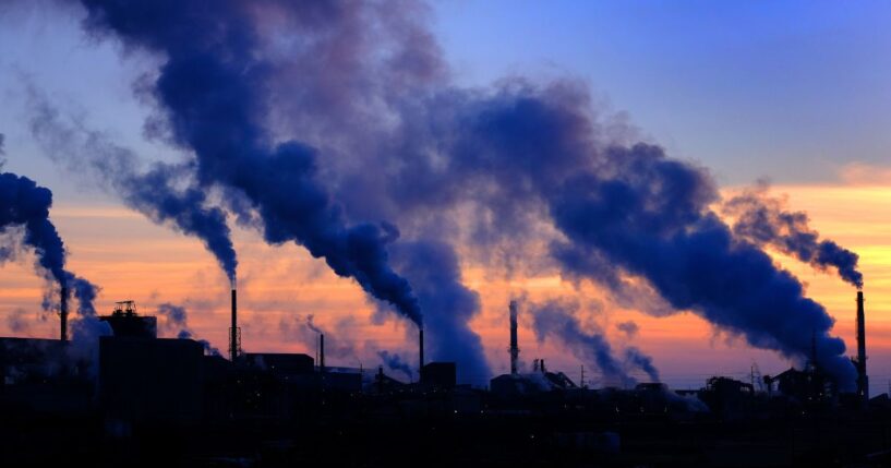 Pollution smoke from a factory plant pumping smoke into the air.