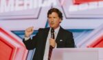 Conservative political commentator and podcast host Tucker Carlson speaks at Turning Point's annual AmericaFest conference, in remembrance of late right-wing political activist Charlie Kirk, in Phoenix, Arizona, on Dec. 18, 2025.