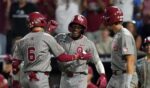 Kyle Branch of the Oklahoma Sooners is congratulated by Dasan Harris and Brendan Brock after hitting a home run during the eighth inning against the North Carolina Tar Heels in Game 3 of the NCAA College World Series baseball finals at Charles Schwab Field on June 22, 2026, in Omaha, Nebraska.