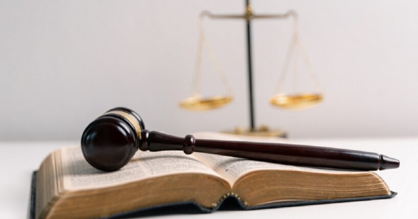 A Bible, a gavel and the scales of justice.