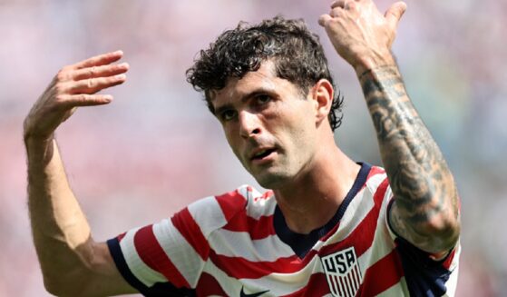 Christian Pulisic of the United States Men's National Soccer Team gestures with both arms raised during the international friendly match between United States and Senegal on Sunday at Bank of America Stadium in Charlotte, North Carolina.