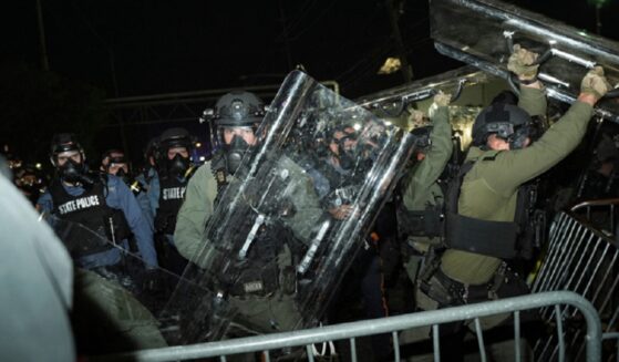 Law enforcement officers fend off anti-ICE protesters during a clash outside the Delaney Hall detention center on Saturday in Newark, N.J.