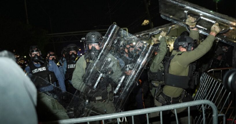 Law enforcement officers fend off anti-ICE protesters during a clash outside the Delaney Hall detention center on Saturday in Newark, N.J.