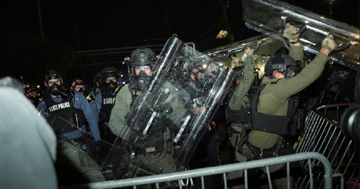 Law enforcement officers fend off anti-ICE protesters during a clash outside the Delaney Hall detention center on Saturday in Newark, N.J.