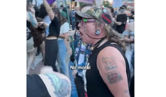 An activist screams outside the Drip Café in Denver. The Christian coffee shop is a perennial target of the militant transgender movement.