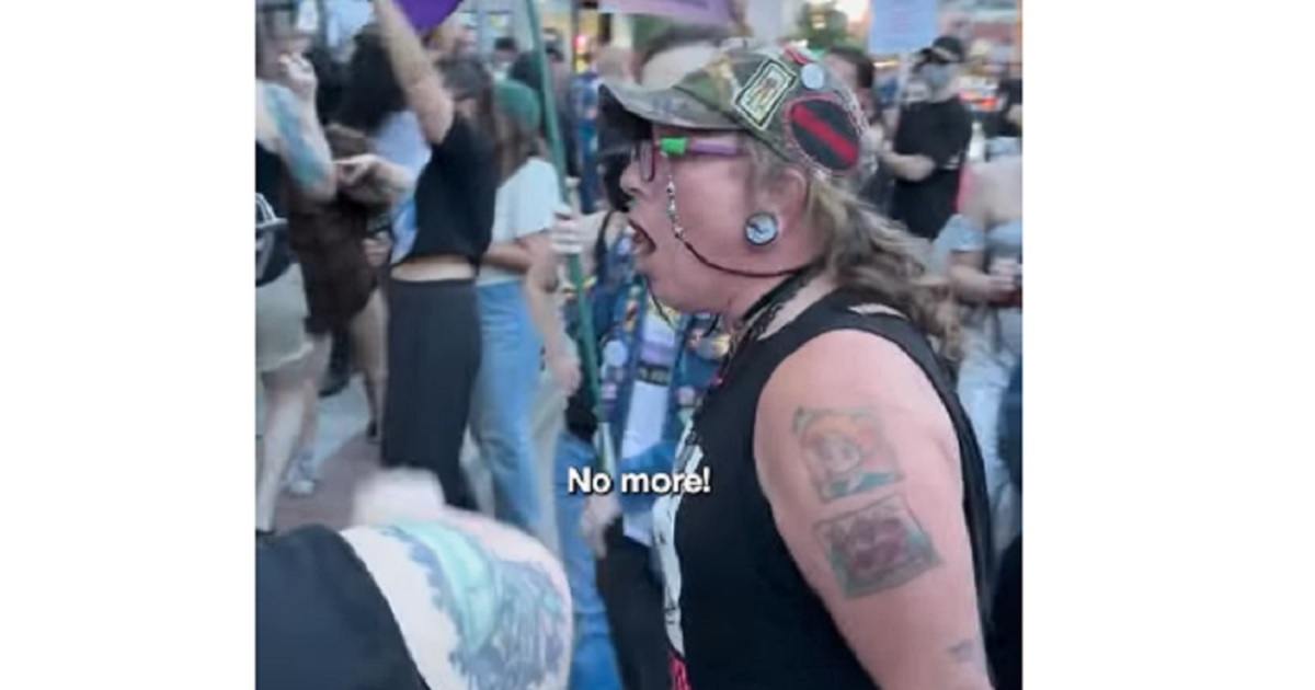 An activist screams outside the Drip Café in Denver. The Christian coffee shop is a perennial target of the militant transgender movement.