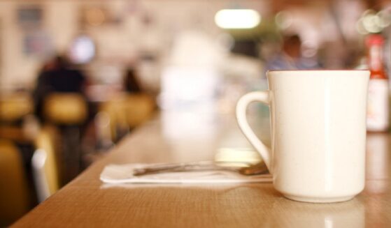 A cup of coffee on a counter in a diner.