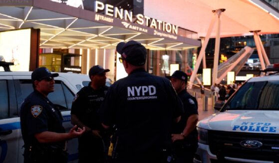 New York City police officers gather outside Penn Station on Sunday after a stabbling that left five wounded.