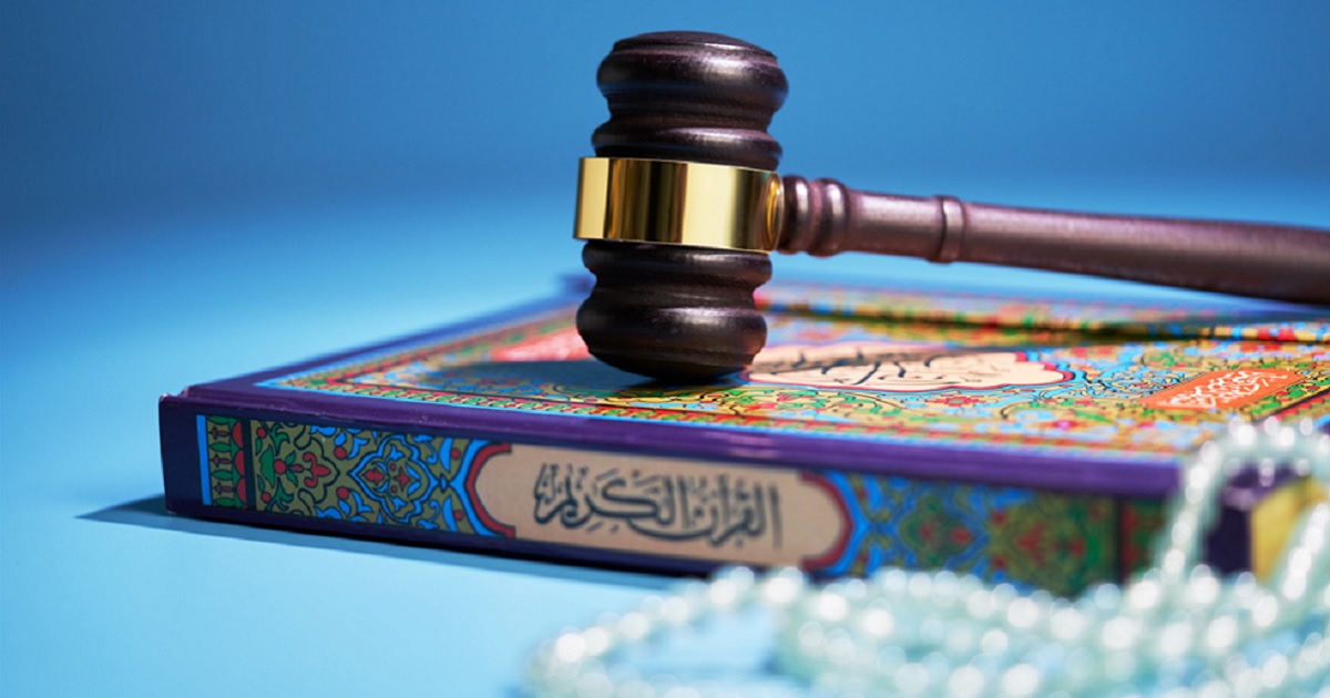 A gavel sits atop a Quran and Islamic prayer beads in a photo illustration.