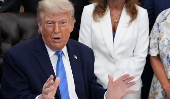 President Donald Trump addresses reporters in the Oval Office on Wednesday.