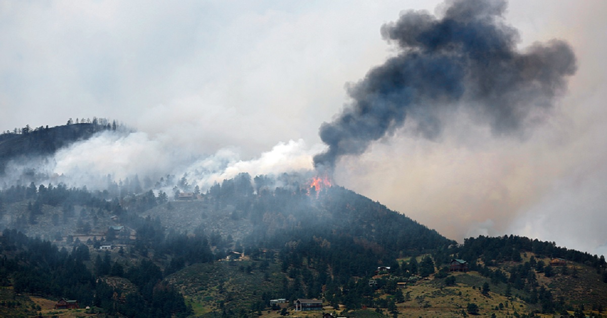 Smoke fills a mountain sky in a file photo from a 2012 wildfire in Colorado.
