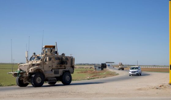 A U.S. military mine-resistant ambush protected armored fighting vehicle drives along a highway outside Qamishli in Syria's northeastern Hasakah province on Feb. 22, 2026.