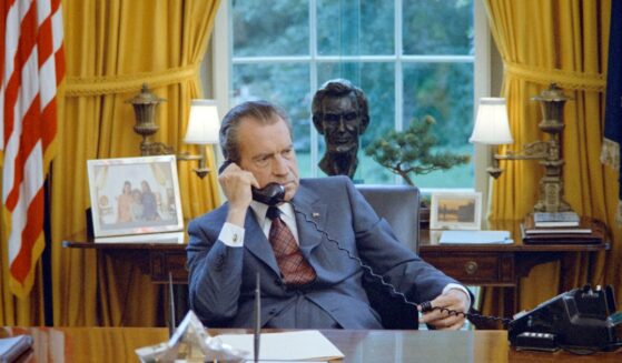 President Richard Nixon talks on the telephone at his desk in the White House's Oval Office, Washington, D.C., on June 23, 1972.