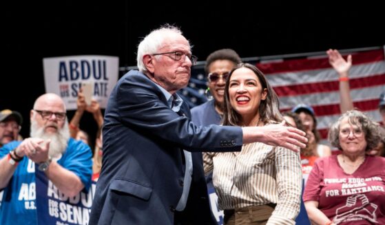 Sen. Bernie Sanders, an Independent from Vermont, greets Rep. Alexandria Ocasio-Cortez, a Democrat from New York, at The People v. The Powerful rally at the Detroit Opera House on July 18, 2026, in Detroit, Michigan.