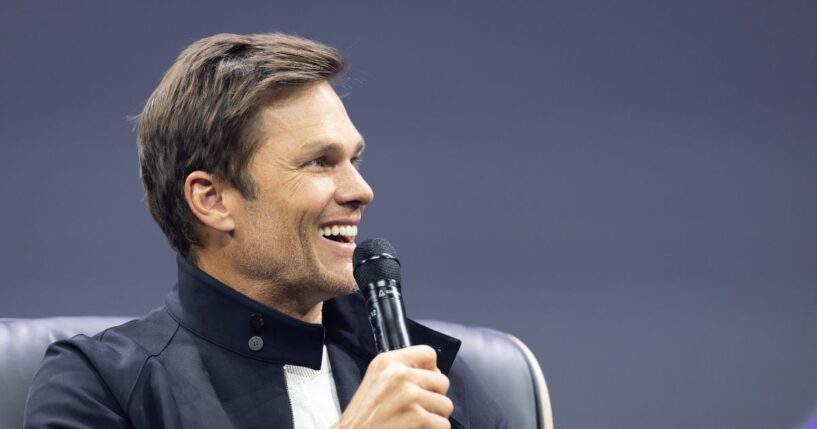 Tom Brady gestures on stage during day two of the annual OMR Festival at Hamburg Messe on May 6, 2026, in Hamburg, Germany.