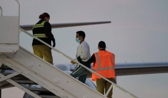A man in shackles boards the first deportation flight of undocumented Venezuelans after a U.S.-Venezuelan agreement in Harlingen, Texas, on Oct. 18, 2023.