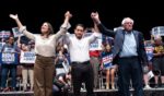 Rep. Alexandria Ocasio-Cortez, Michigan Democratic candidate for Senate Abdul El-Sayed, and Sen. Bernie Sanders greet the crowd after El-Sayed spoke at The People v. The Powerful rally at the Detroit Opera House on July 18 in Detroit, Michigan.