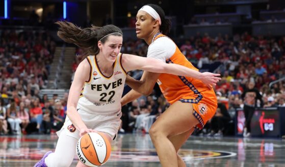 Caitlin Clark of the Indiana Fever dribbles the ball while defended by Nell Angloma of the Connecticut Sun at Gainbridge Fieldhouse on July 22, 2026, in Indianapolis, Indiana.