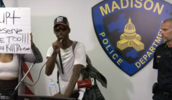 A demonstrator interrupts a police briefing on July 23, 2026, in Madison, Wisconsin.