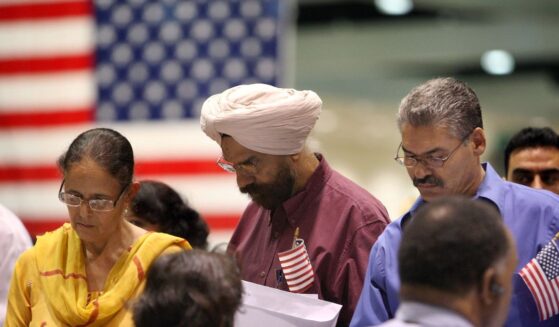 Amrik Sidhu and his wife Harjinder Sidhu, both Sikhs from India, apply for their passports after gaining U.S. citizenship as 18,418 people are sworn in as citizens during naturalization ceremonies at the Los Angeles Convention Center on Aug. 28, 2008, in Los Angeles, California.