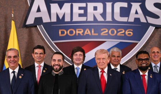 President Donald Trump stands with foreign leaders during a group photograph at the start of the Shield of the Americas Summit at the Trump National Doral Golf Club on March 7, 2026, in Doral, Florida.