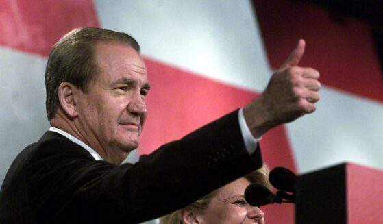 Reform Party presidential candidate Pat Buchanan, flanked by his wife Shelly, gives the thumbs-up to supporters after his Aug. 12, 2000, speech at the Reform Party National Convention in Long Beach, California.