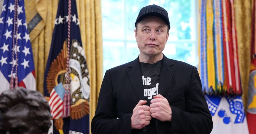 Tesla CEO Elon Musk listens as President Donald Trump speaks to reporters in the Oval Office of the White House on May 30, 2025, in Washington, D.C.
