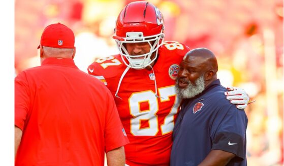 Travis Kelce #87 of the Kansas City Chiefs, is seen in a file photo dated Aug. 22, 2025, greeting former Chiefs offensive coordinator Eric Bieniemy, right, who at the time was running backs coach with the Chicago Bears.