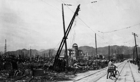 A man wheels his bicycle thorough Hiroshima, Japan, days after the city was leveled by an atomic bomb blast on Aug. 6, 1945.