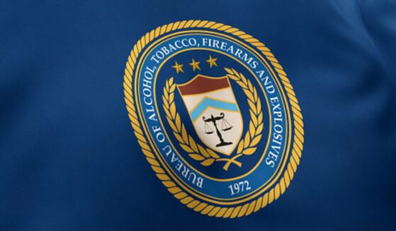 The Bureau of Alcohol, Tobacco, Firearms and Explosives flag waves under white lighting.