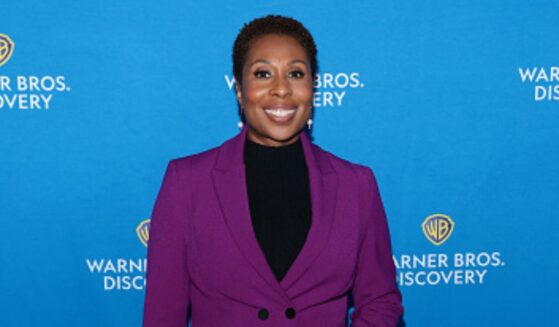 “CNN This Morning” host Audie Cornish stands at a red carpet in a purple pantsuit on May 15, 2025.