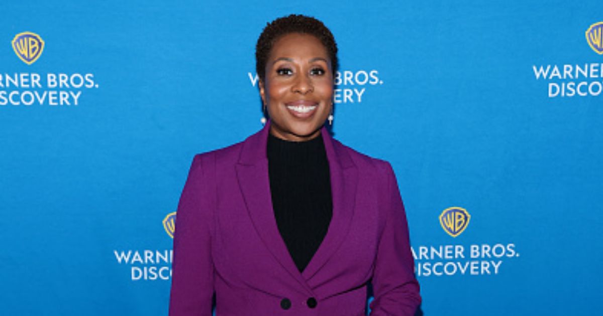 “CNN This Morning” host Audie Cornish stands at a red carpet in a purple pantsuit on May 15, 2025.