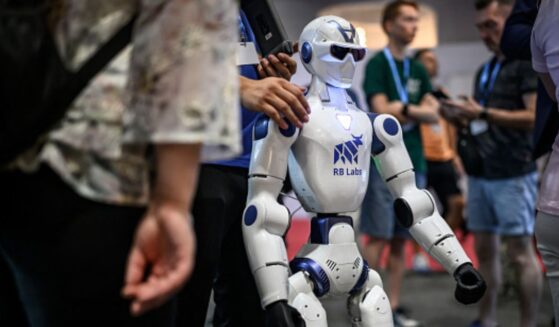A robot stands amongst a crowd at the AI for Good Global Summit on July 7, 2026.