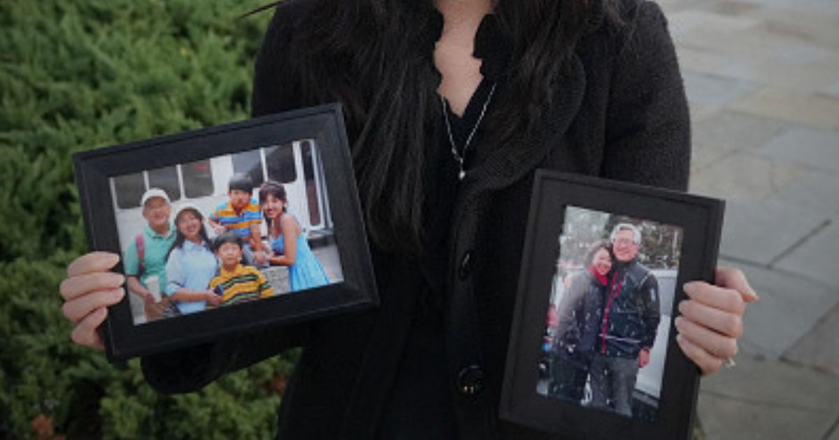 Grace Jin Drexel stands with photos of her father, Ezra Jin, on October 30, 2025 in Washington, D.C. during an interview.