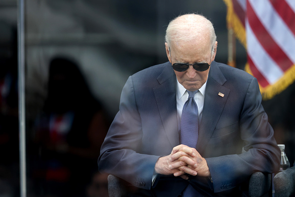 President Joe Biden sits with his head lowered at the Obama Center dedication on June 18, 2026.