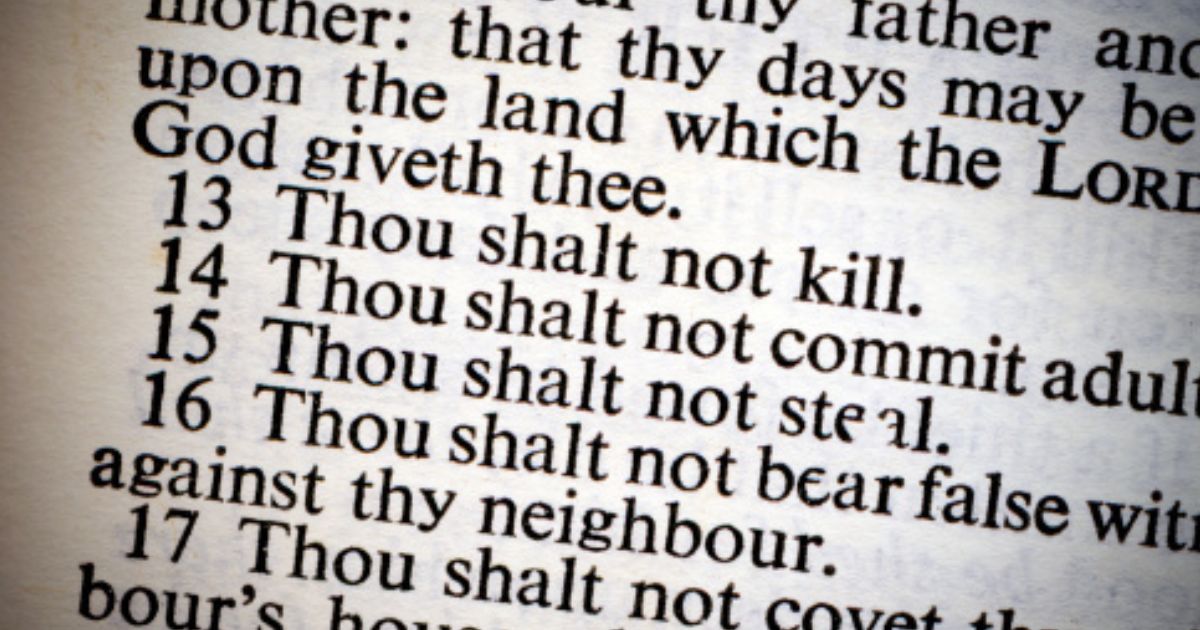 A photo of the Ten Commandments on a lit piece of paper is pictured.