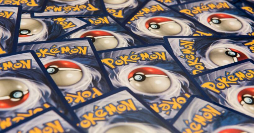 Pokémon Cards lay on a table.