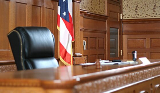 A wooden courtroom sits empty.