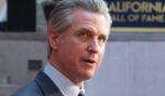 Gavin Newsom looks to photographers at the 19th California Hall of Fame ceremony on March 19, 2026.