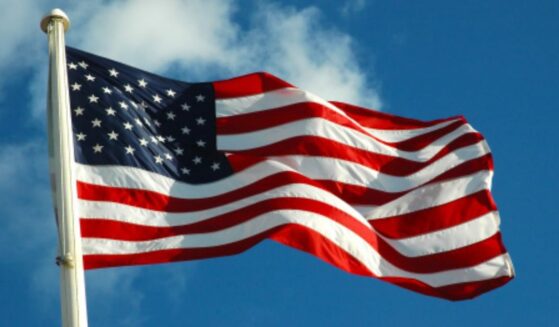The American flag waves in the wind on a bright afternoon.