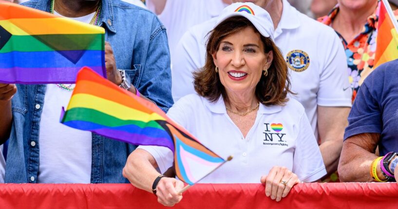 New York Gov. Kathy Hochul waves a transgender flag during the 2026 