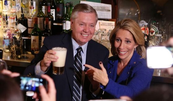 GOP Sen. Lindsey Graham of South Carolina and his sister, Darline Graham Nordone, serve guests prior to CNN's "Politics On Tap" at Walnut Brewery on Oct. 27, 2015, in Boulder, Colorado.