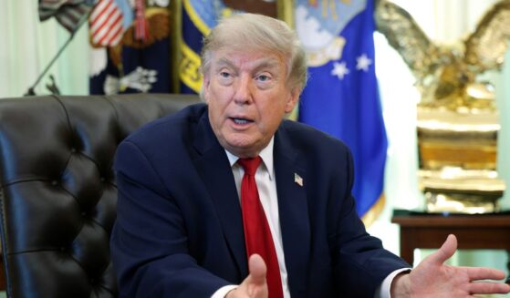 President Donald Trump sits at the desk in the Oval Office of the White House as he speaks to reporters on June 29, 2026 in Washington.