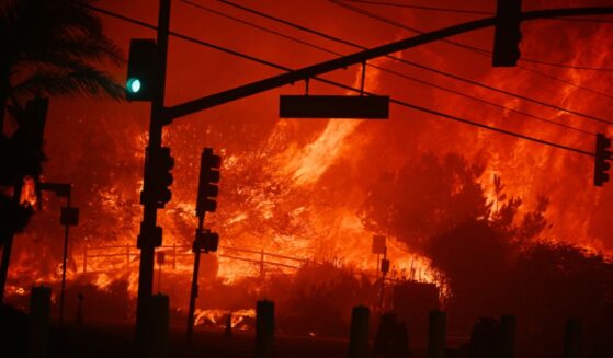 Flames engulf the intersection of Temescal Canyon and the Pacific Coast Highway as the Palisades Fire devastates a Los Angeles suburb on Jan. 7, 2025.