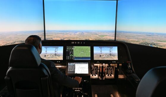 A man sits inside the cockpit of a flight simulator for the Overture Supersonic Airliner at the Boom Supersonic exhibition hall at Farnborough International Exhibition in Farnborough, England, on July 23, 2024.