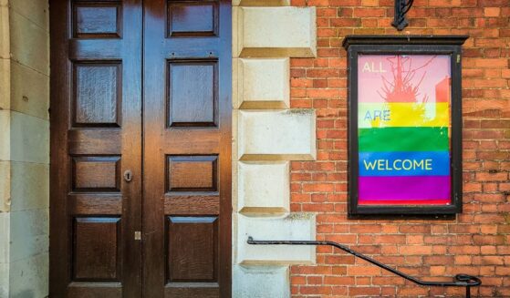 An LGBT-affirming sign posted outside the front door to a Christian church.