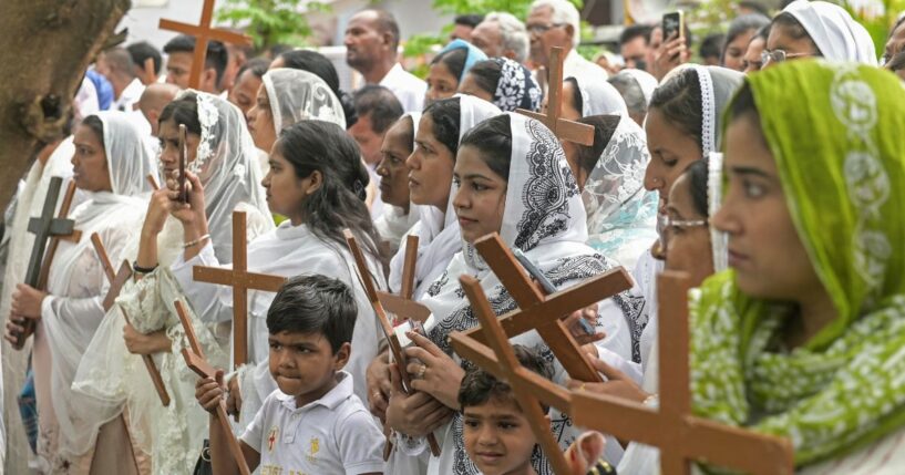 Christians hold up crosses in Amritsar, India, during a Good Friday procession on April 3, 2026.