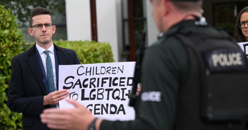 Members of the family of Enoch Burke, a teacher at the center of a case regarding pronoun usage, protest outside the La Mon hotel in Comber, Northern Ireland on Sept. 20, 2025.